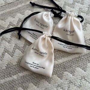 Kate Spade Cream Drawstring Pouches